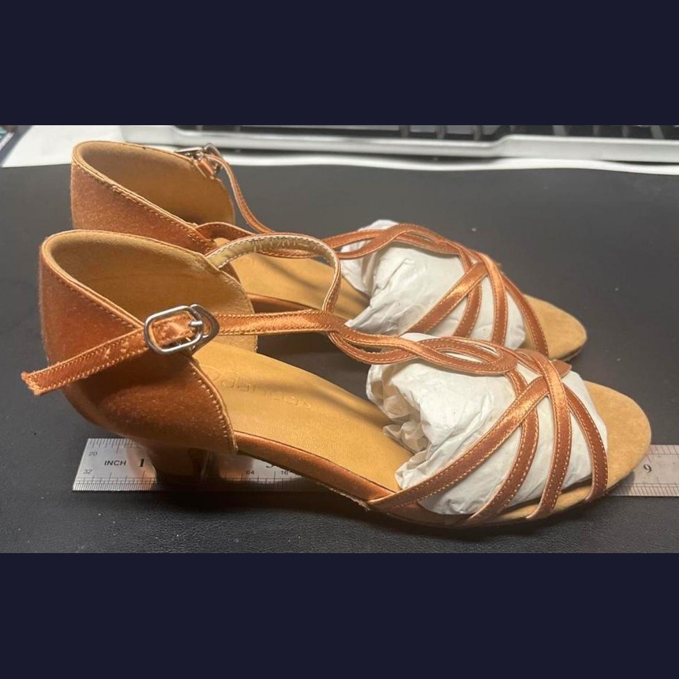 Bronze dance shoes, size 4, side view against a ruler showing shoe length