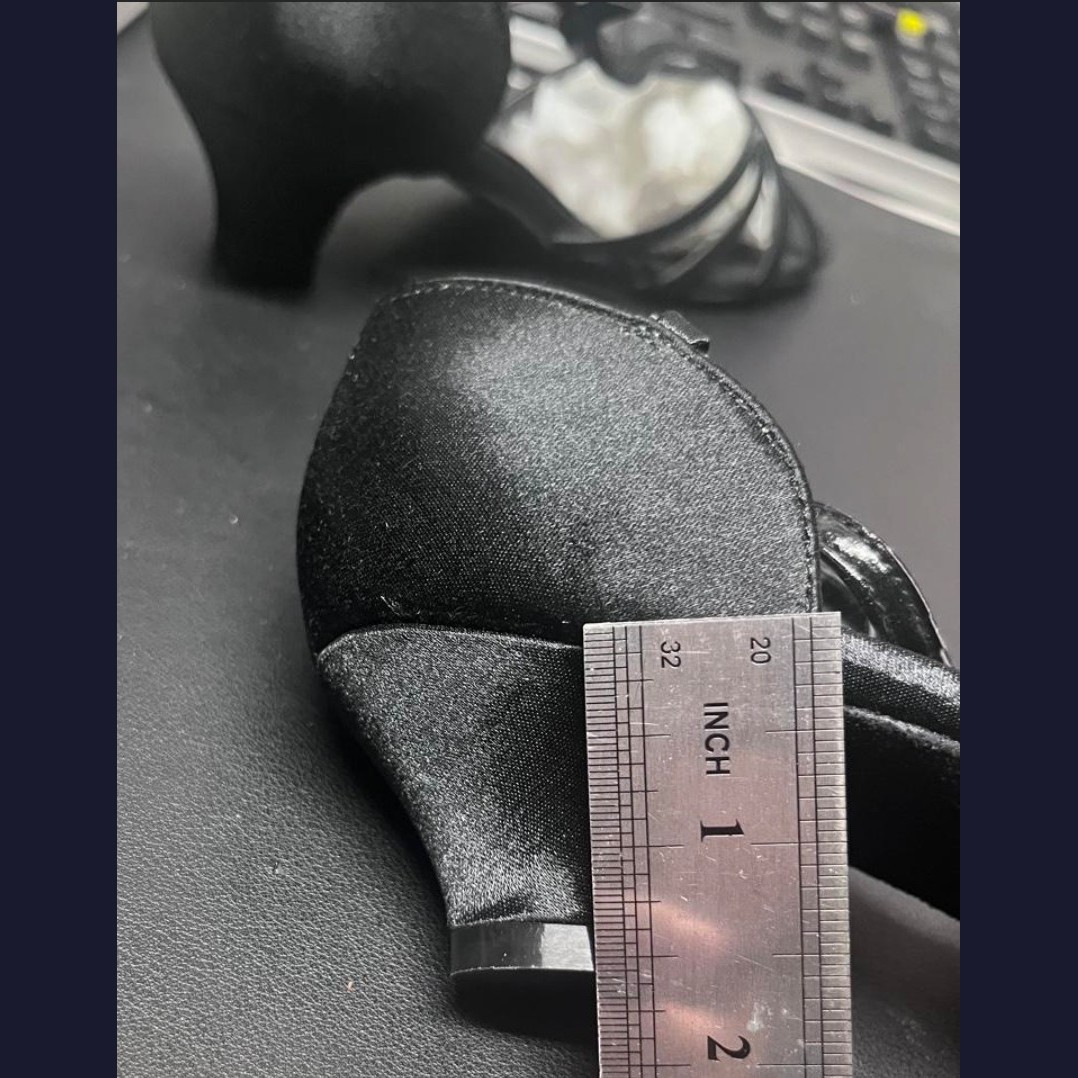 Black dance shoes, size 5, heel closeup against a ruler